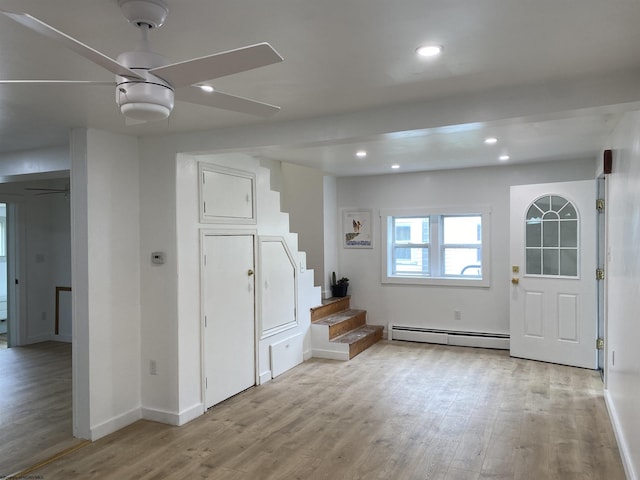 interior space featuring light hardwood / wood-style flooring, ceiling fan, and a baseboard radiator