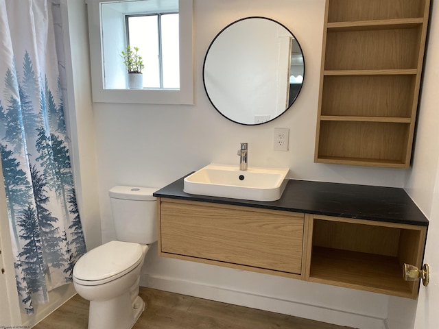 bathroom with vanity, toilet, hardwood / wood-style flooring, and curtained shower