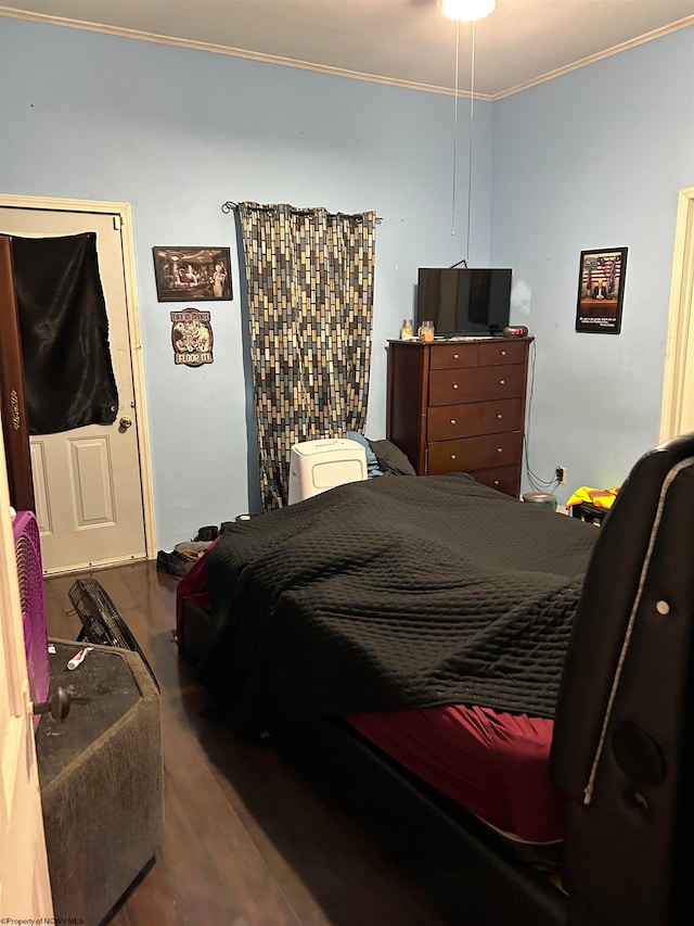 bedroom with ornamental molding and wood-type flooring