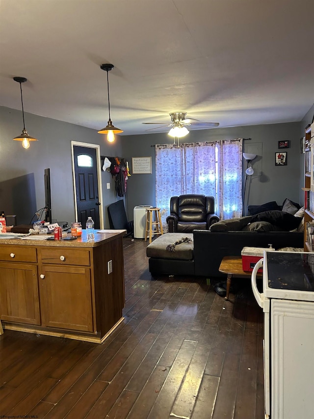 kitchen featuring ceiling fan, dark hardwood / wood-style flooring, and pendant lighting