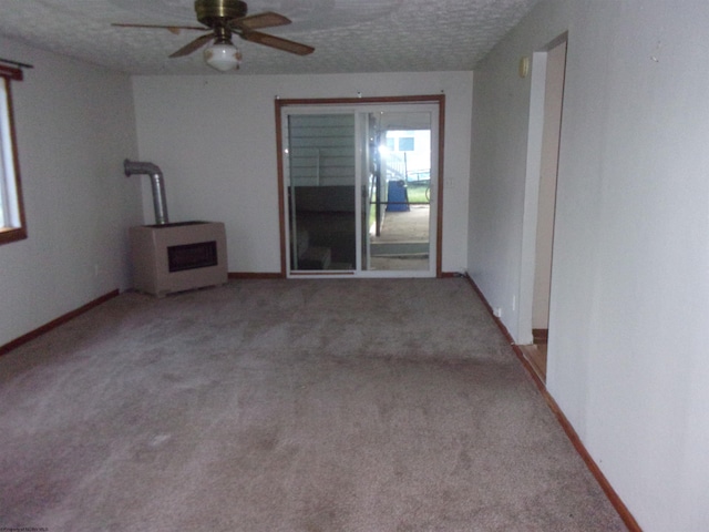 carpeted empty room with ceiling fan and a textured ceiling