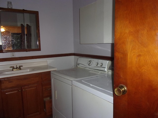 washroom with independent washer and dryer and sink