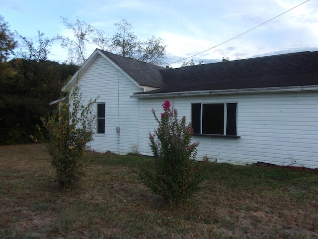 view of property exterior with a yard