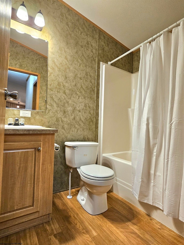 full bathroom with vanity, toilet, shower / bath combo, crown molding, and hardwood / wood-style floors