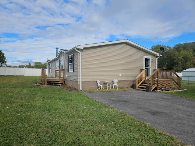 view of property exterior featuring a deck and a yard