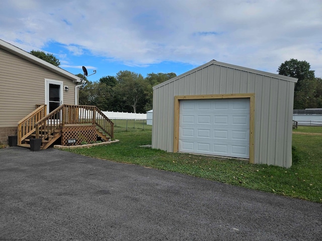 garage with wooden walls and a yard