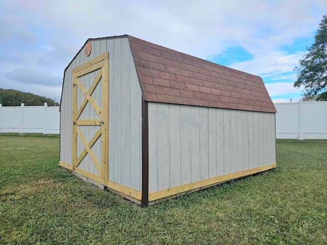 view of outdoor structure featuring a lawn