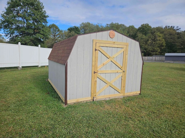 view of outbuilding with a lawn