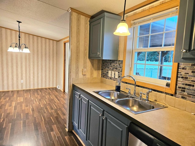 kitchen featuring pendant lighting, dark wood-type flooring, sink, and a healthy amount of sunlight