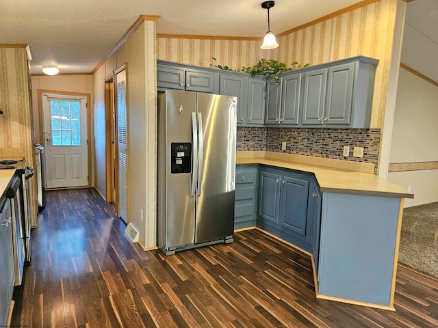 kitchen featuring ornamental molding, decorative light fixtures, stainless steel appliances, dark hardwood / wood-style floors, and decorative backsplash