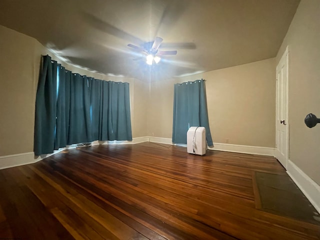 empty room featuring dark hardwood / wood-style flooring and ceiling fan