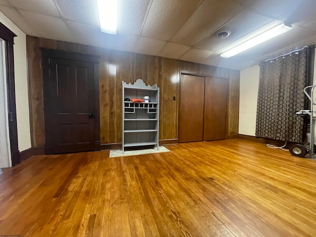 interior space featuring hardwood / wood-style flooring and a paneled ceiling