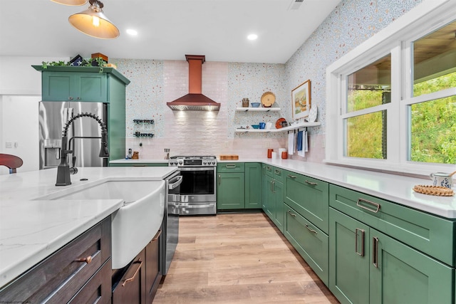 kitchen featuring light hardwood / wood-style floors, tasteful backsplash, light stone countertops, stainless steel appliances, and custom exhaust hood