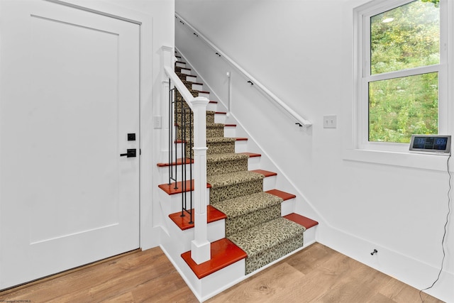 stairs featuring hardwood / wood-style flooring