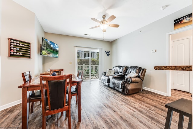 dining room with ceiling fan and hardwood / wood-style floors