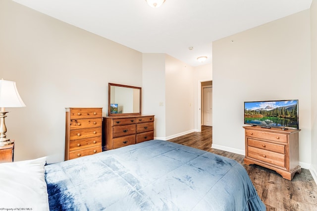 bedroom with dark hardwood / wood-style flooring