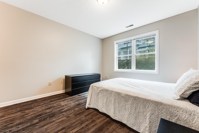 bedroom with dark wood-type flooring