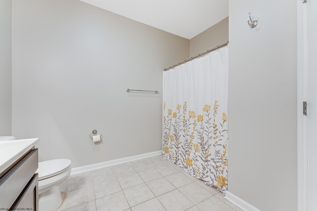 bathroom with a shower with shower curtain, vanity, toilet, and tile patterned floors