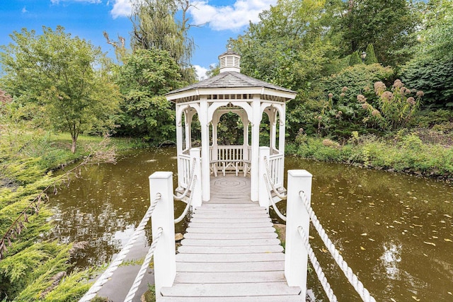 view of dock with a gazebo and a water view