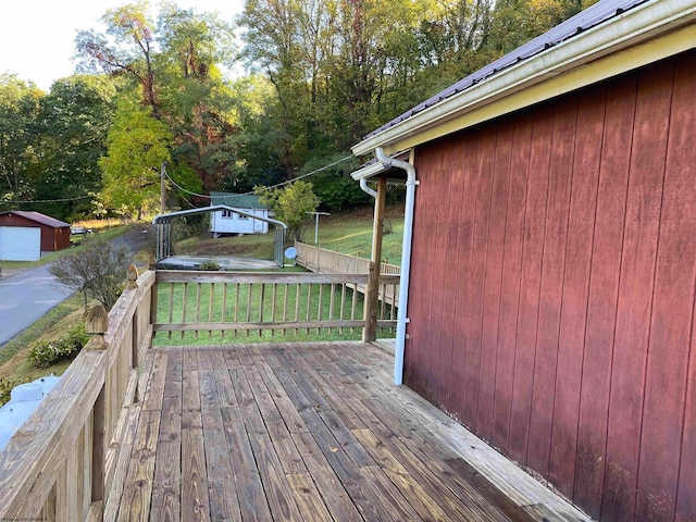 wooden deck featuring an outdoor structure and a garage