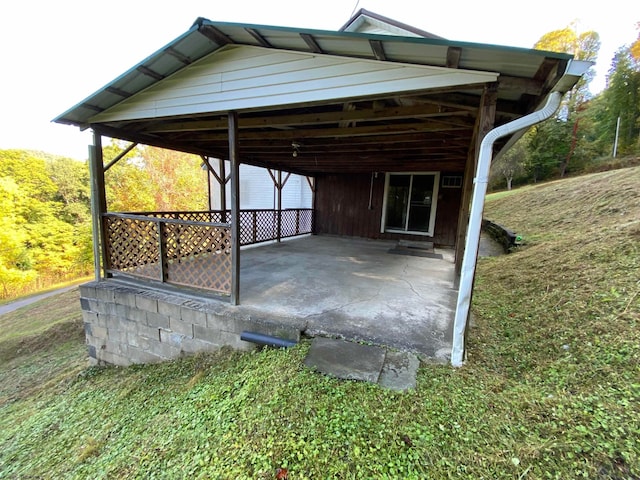 view of car parking featuring a lawn and a carport