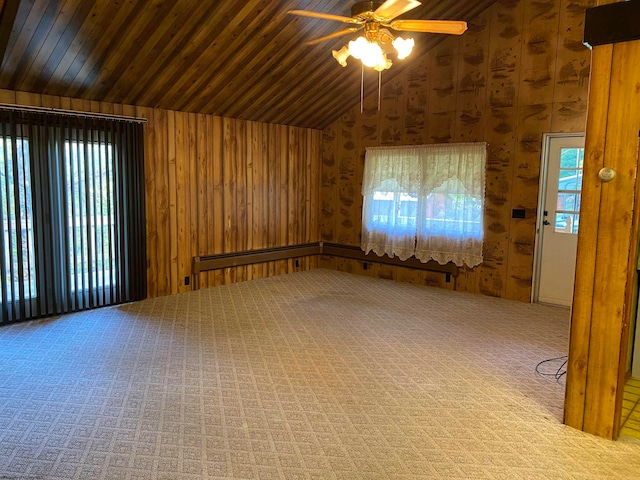 spare room featuring wood ceiling, wood walls, lofted ceiling, ceiling fan, and carpet