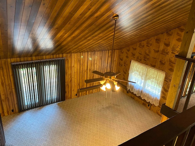 interior space featuring vaulted ceiling, ceiling fan, wooden ceiling, and carpet floors