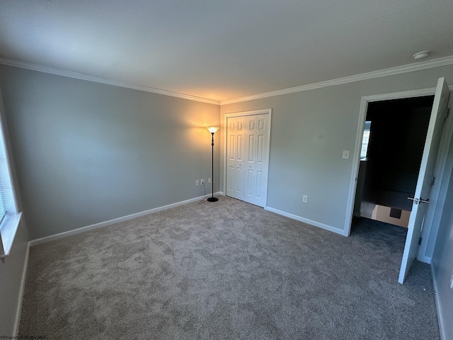 unfurnished bedroom with ornamental molding, dark colored carpet, and multiple windows