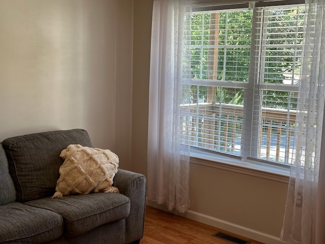 sitting room with wood-type flooring