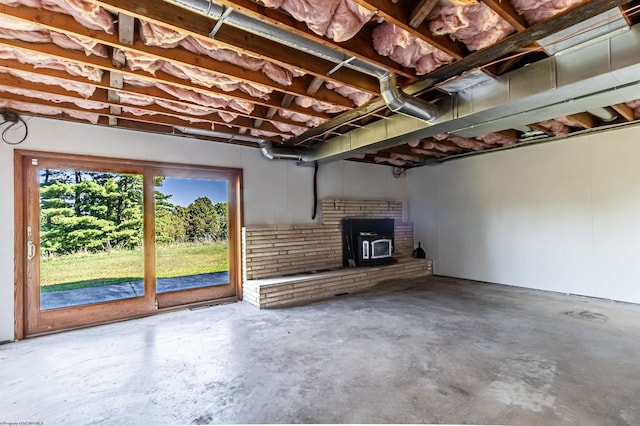 basement with a fireplace and a wood stove