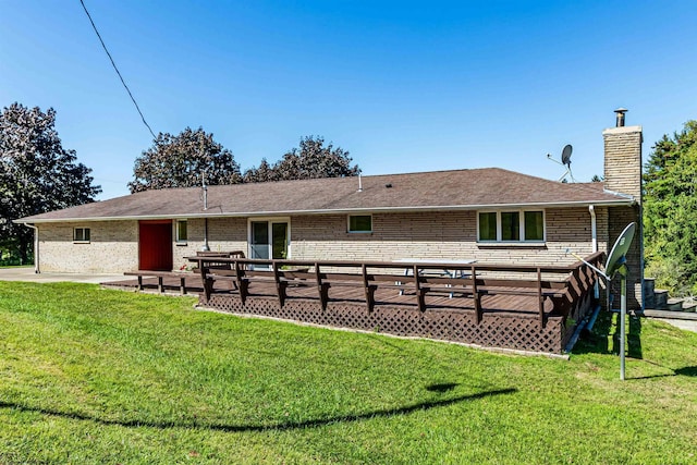 back of property with a wooden deck, a yard, and a patio area