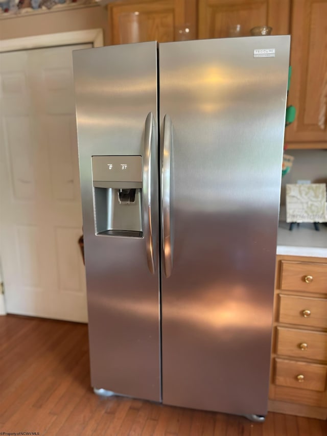 kitchen with stainless steel refrigerator with ice dispenser and light hardwood / wood-style floors