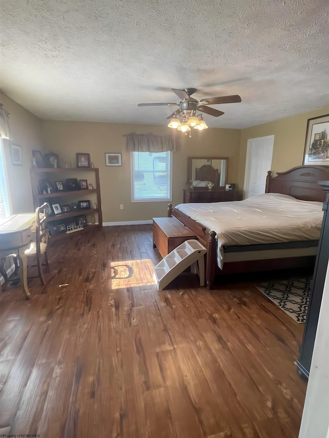 unfurnished bedroom with ceiling fan, a textured ceiling, and dark hardwood / wood-style floors