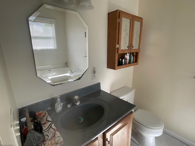 bathroom featuring vanity, toilet, and tile patterned floors