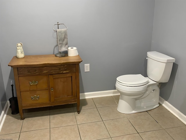 bathroom featuring tile patterned flooring, vanity, and toilet