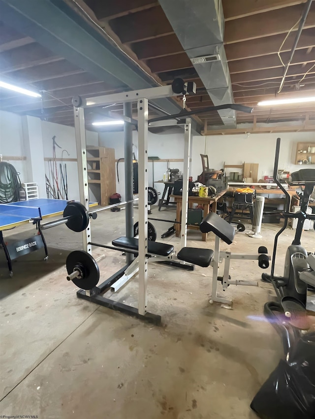 workout room featuring concrete floors