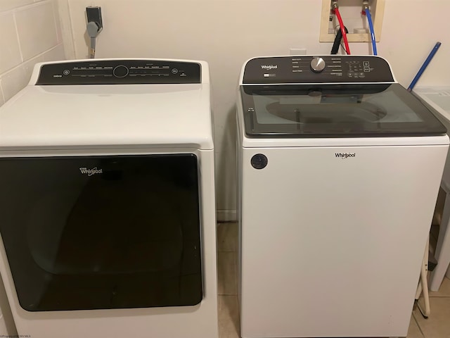 laundry room with separate washer and dryer and tile patterned floors