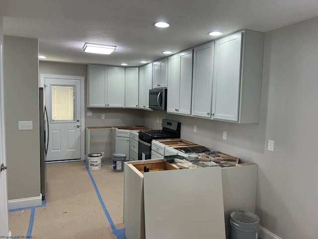 kitchen with white cabinetry and appliances with stainless steel finishes