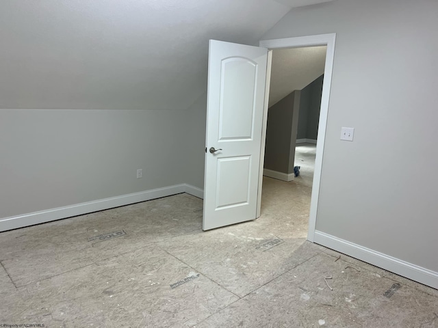 additional living space featuring vaulted ceiling