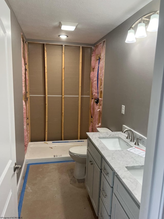 full bathroom featuring vanity, a textured ceiling, concrete flooring, shower / tub combination, and toilet