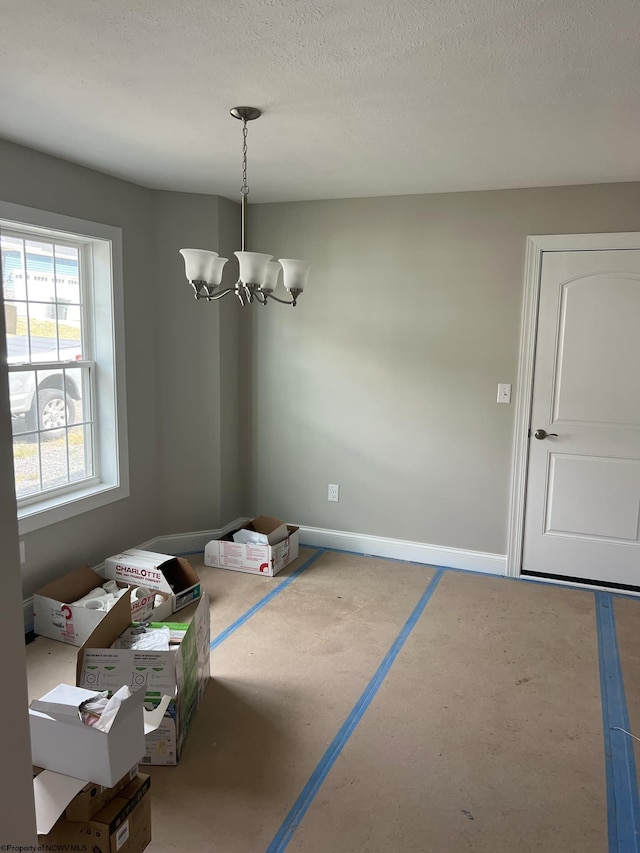 dining room featuring a notable chandelier and a textured ceiling