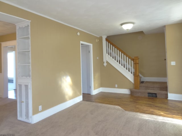 interior space with wood-type flooring and crown molding