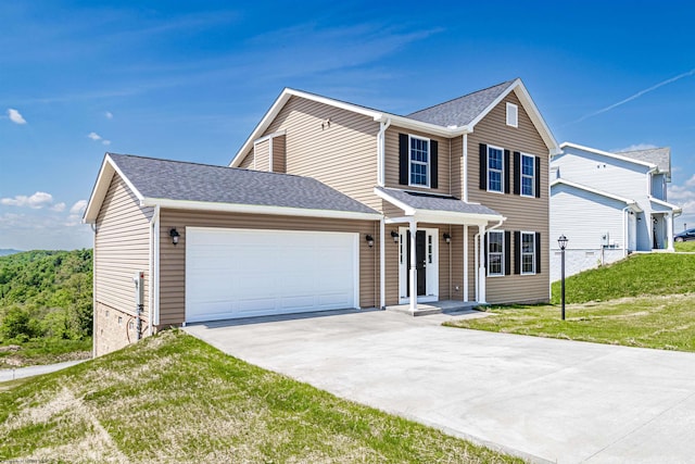 view of front of property featuring a front lawn and a garage