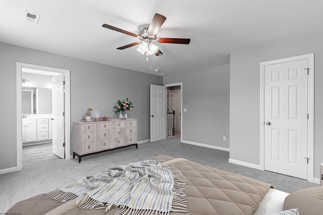 carpeted bedroom featuring ensuite bath and ceiling fan