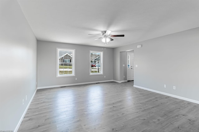 empty room featuring ceiling fan and light hardwood / wood-style flooring