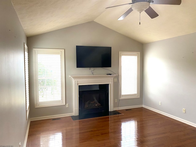 unfurnished living room featuring vaulted ceiling, dark hardwood / wood-style floors, and ceiling fan