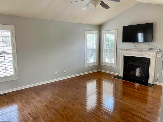 unfurnished living room with vaulted ceiling, ceiling fan, and hardwood / wood-style floors