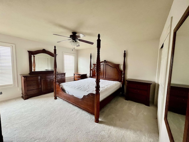bedroom with ceiling fan and light carpet
