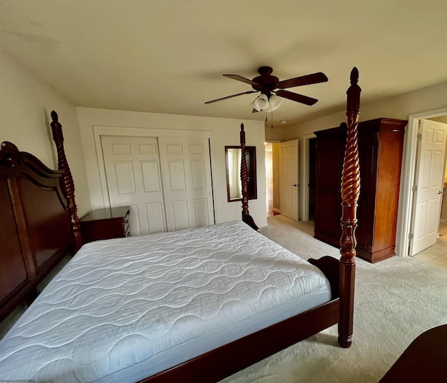 bedroom with light colored carpet, a ceiling fan, and a closet