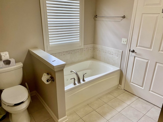 bathroom featuring a bathtub, toilet, and tile patterned floors